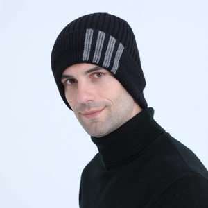 Detailed close-up of thick ribbed knit texture on black wool beanie for winter