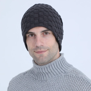Detail of dark grey knit beanie with square pattern texture and round fabric patch