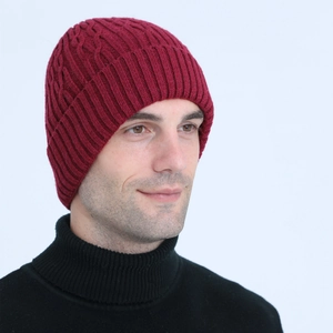 Detailed knit pattern of a burgundy wool beanie with thick braided twist and vertical stripes