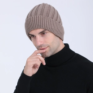 Close-up of brown ribbed knit beanie with thick wool texture and folded cuff style