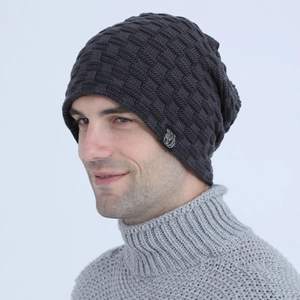 Close-up of men's dark grey knit beanie with checkerboard texture and woven label