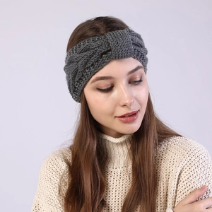 Detail of dark grey cable knit headband with twisted knot design on model