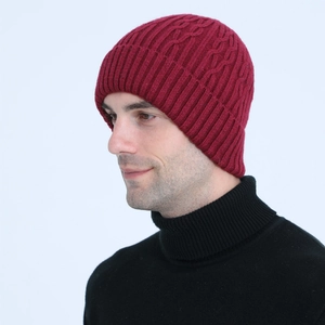 Close-up of wine red men's cable knit beanie featuring thick texture and ribbed design