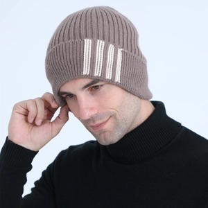 Close-up of taupe knit beanie with fleece lining and white stripes for winter