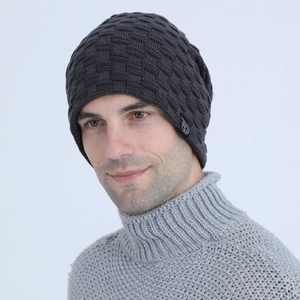 Detail of dark grey textured knit beanie featuring a black woven label on the side