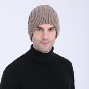 Detail of light brown ribbed knit beanie showing high-quality wool texture and folded cuff