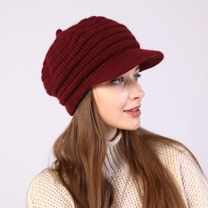 Detail of burgundy striped knit visor beanie with fleece lining and warm texture