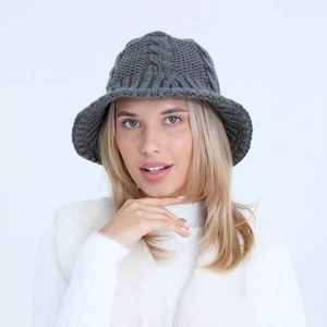 Detailed view of dark grey chunky cable knit bucket hat with warm textured finish