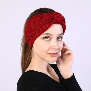 Close-up of red cable knit headband showing thick wool texture and twisted bow detail
