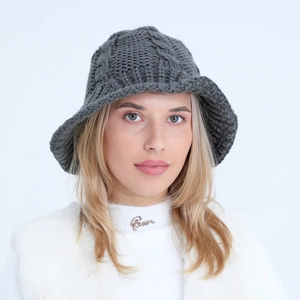 Detail of dark grey knit bucket hat featuring thick twist pattern and textured wool