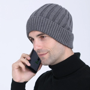 Male model wearing a thick dark grey ribbed knit beanie for winter outdoor warmth