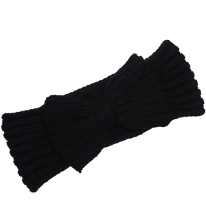 Detail view of a black ribbed knit headband with a large decorative bow for winter warmth