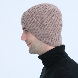 Detail of men's knit beanie showing cable pattern and soft fleece-lined texture