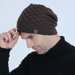 Detail of dark brown cable knit beanie with fleece lining and polar bear logo patch