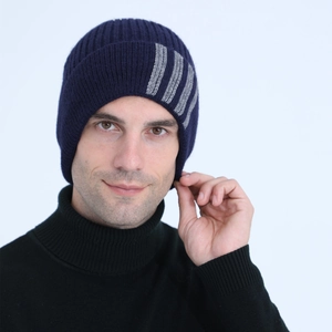 Detail showing navy knit beanie with gray stripes and soft wool texture for men