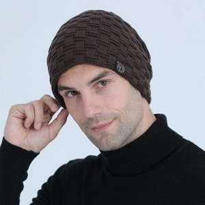 Macro detail of men's dark brown beanie featuring brick-pattern knit and woven label