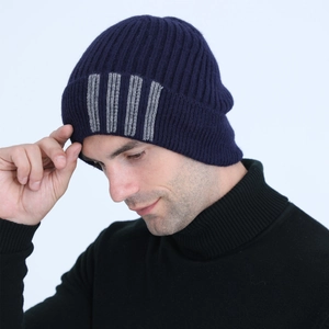 Detail of dark blue ribbed knit beanie with grey vertical stripes and fleece lining