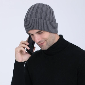 Detail of gray ribbed knit beanie showing thick wool texture and warm ear protection