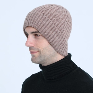 Close-up of cable knit beanie showing thick wool texture and warm ear protection fit