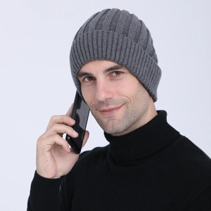 Detail of grey ribbed knit beanie showing vertical texture and thick wool material