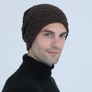 Detail of dark brown knitted beanie with textured waffle pattern and cozy fleece lining