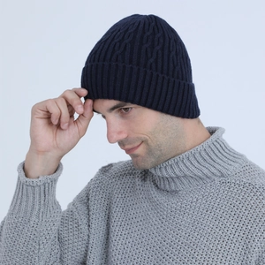 Close-up of navy blue cable knit beanie with warm fleece lining and ribbed texture