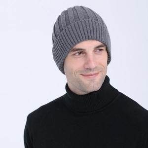 Close-up of grey ribbed knit beanie with folded cuff on male model for winter warmth