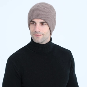 Close-up of brown cable knit beanie with diamond pattern on high quality fabric