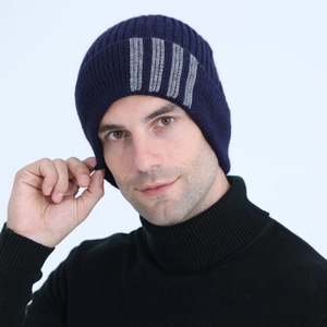 Close-up of men's dark blue ribbed knit beanie with grey stripes for winter warmth
