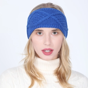 Close-up detail of cobalt blue cable knit headband with twisted knot design for women