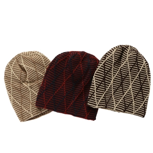 Detail view of winter knit beanies showing diamond patterns in multiple color variations