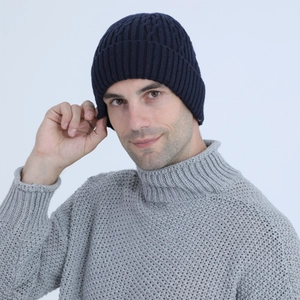 Close-up of navy blue winter beanie with thick knit texture and warm fleece lining