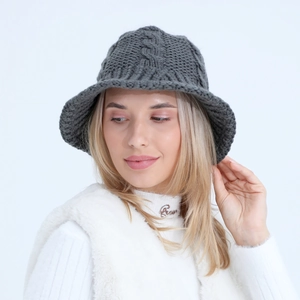 Detail of dark grey cable knit bucket hat showing soft wool texture and chunky weave