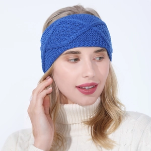 Close-up of royal blue knitted cable pattern headband worn by a model in winter