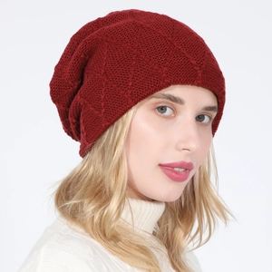 Detail of red knit beanie with diamond texture on a model for winter warmth