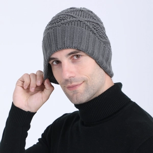 Close-up of the intricate diamond pattern and ribbed texture on this charcoal knit beanie