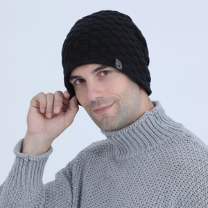 Detail of black winter beanie with square knit texture and unique animal patch