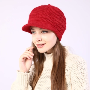 Detail of red striped knit visor beanie with thick warm texture for women