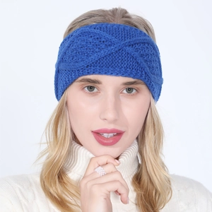 Macro detail of winter bright blue cable knit headband featuring cross-twist pattern design