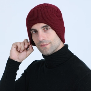 Close-up of cable knit texture and pattern on this burgundy winter beanie for men