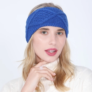 Close-up of royal blue knitted headband with a twist design and soft cable textures