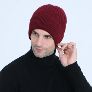 Detailed texture of dark red cable knit beanie with warm fleece lining for men