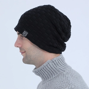 Macro detail of black knit beanie with square texture and animal logo woven label