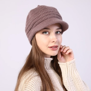 Detail of warm striped knit beanie with visor showing thick ribbed texture and pinkish tone
