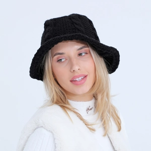 Detailed view of thick knit texture and cable pattern on this black winter bucket hat