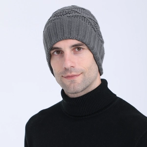 Detailed texture of gray knit beanie with ribbed cuff and diamond jacquard pattern