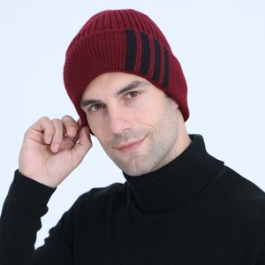 Close-up of burgundy ribbed knit beanie with three black decorative side stripes