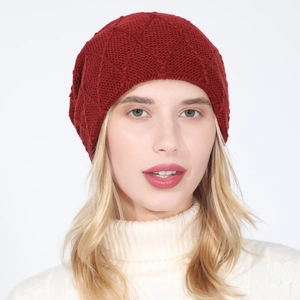 Detailed close-up of red knitted beanie featuring premium diamond pattern texture