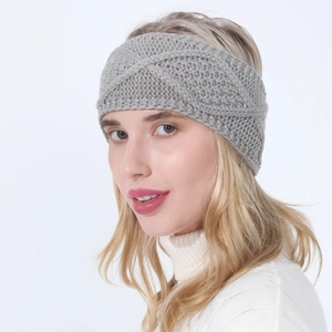 Close-up of grey cable knit headband with thick yarn and twist pattern texture