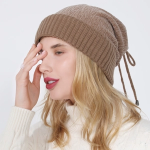 Detail view of brown knit beanie with wide ribbed edge and adjustable drawstring back